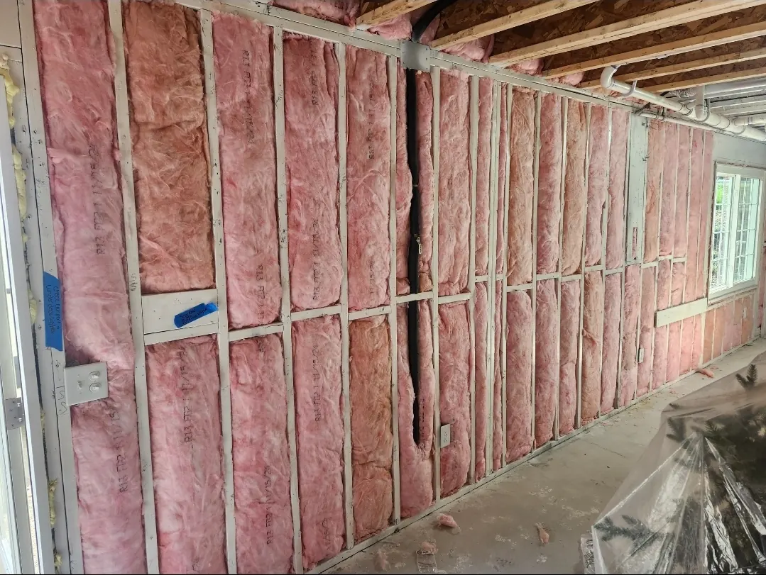 Long exterior wall filled with R-13 fiberglass batts between metal studs